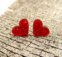 A little glam goes a long way with these Red Glitter Heart Stud Earrings! ♥ Little Heart Pendants are made of laser cut red glitter acrylic. ♥ Each Heart measures .5″ across. ♥ Pick which Stud Post these are made with! -Nickel Free Posts -Stainless Steel -Plastic Posts -Clip Ons -Titanium Posts ♥ Makes a loving Valentine's Day Gift or any day Gift! Comes in a cute little gift box. Minimalistic, yet a bold statement of love and glitter. 💖 -------◆-◆-◆------- Join the ★Email★ List and get a Sign Red Glitter Earrings For Gift, Glitter Red Earrings For Gifts, Valentine's Day Sparkling Heart Earrings For Party, Romance Gifts, Pink Heart Earrings, Tech Jewelry, Red Heart Earrings, Cosplay Jewelry, Valentines Presents