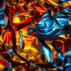 an image of shiny material that looks like it is going to be painted red, yellow and blue