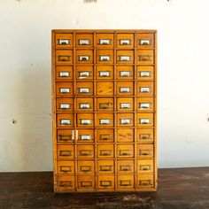 an old wooden filing cabinet with many drawers