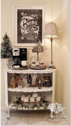 a white shelf filled with lots of items next to a wall mounted chalkboard sign