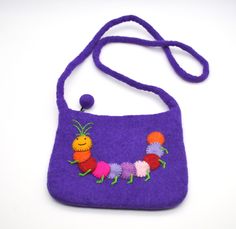 This little bag is utterly adorable!    Your little one will have the only one like it, and it's made so well it will last for years.  The body of the bag and strap is made with thick felted wool and features a colouful caterpillar.  There is a secure zip across the top, and the bag measures 20cm wide, 16cm high, and the strap is 55cm long. A unique & charming gift for any child! Handmade Fun Rectangular Bag, Fun Handmade Bags For Daily Use, Handmade Fun Bags For Gifts, Playful Shoulder Bag With Adjustable Strap As Gift, Cute Purple Shoulder Bag For Gift, Cute Purple Shoulder Bag Gift, Handmade Fun Bags For Everyday Use, Fun Handmade Bags For Everyday Use, Playful Satchel Shoulder Bag For Gift