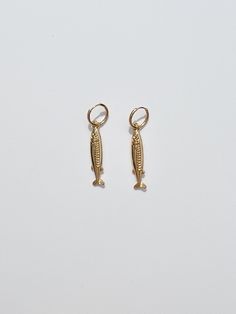 Make a statement with these golden Anchovy Earrings– perfect for any seafood enthusiast! 🎣 They're sure to make a splash! 🌊 Details Gold plated hoop earrings with anchovy charms.1.25" gold plated charms on 0.5" gold plated hoops with hinge closure. Nickel free. Metal Huggie Jewelry With Charms, 14k Gold-filled Hoop Jewelry With Dangling Charms, Brass Small Hoop Jewelry With Charms, Small Hoop Brass Jewelry With Charms, Charm Drop Earrings For Gifts, Tarnish Resistant Dangle Brass Huggie Earrings, Tarnish Resistant Brass Dangle Huggie Earrings, Gold-tone Tarnish Resistant Dangle Earrings, Gold Plated Hoop Jewelry With Dangling Charms