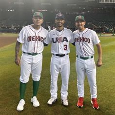 two baseball players standing next to each other on top of a grass covered field in front of an empty stadium