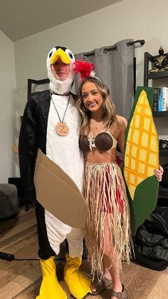 two people in costumes standing next to each other on a wooden floor and one person wearing a chicken costume