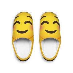 a pair of yellow slippers with smiley faces on the front and back, both in different colors