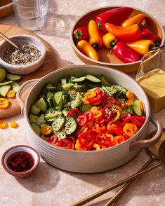 two bowls filled with different types of vegetables and seasoning next to some chopsticks