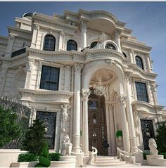 a large white building with statues on the front and side steps leading up to it