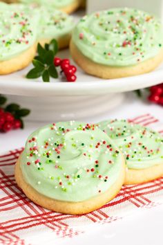 cookies with green frosting and sprinkles on plates