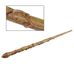 a long wooden stick with an intricate design on it's end is shown in this image