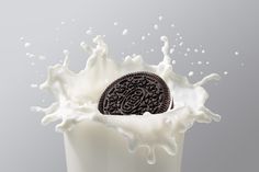 an oreo cookie in a milk splash