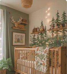 a baby's room decorated with deer and pine trees