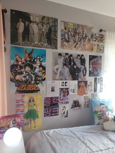 a bedroom with posters on the wall and a bed