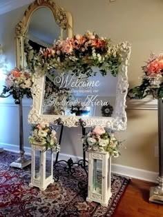 an ornate mirror with flowers on it is sitting in front of a floral arch that reads welcome to the bride and groom