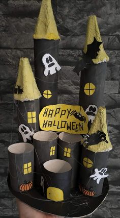 a cake made to look like a castle with halloween decorations on it and the words happy halloween