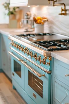 a blue stove top oven sitting inside of a kitchen next to a white counter top