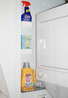 an open refrigerator door with cleaning products on the shelf