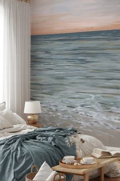 a bedroom with a large painting on the wall next to a bed and coffee table