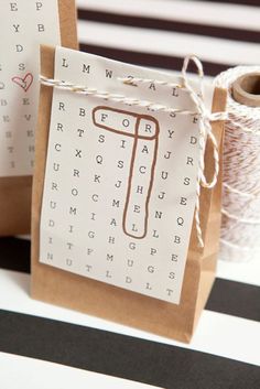 two brown paper bags sitting on top of a table