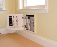 an open binder on the wall in a room with yellow walls and tan carpet