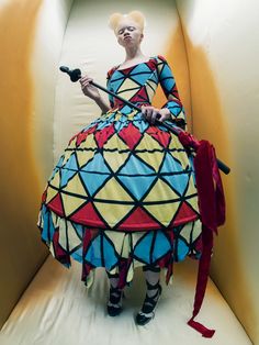 a woman in a colorful dress holding an umbrella