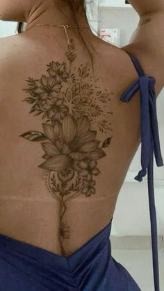 the back of a woman's body with flowers on it