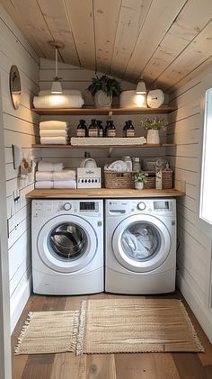 a washer and dryer in a small room with wood paneling on the walls