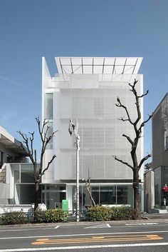 an empty street in front of a white building