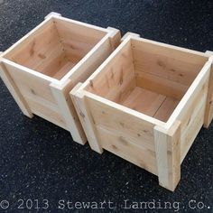 three wooden planters sitting on the ground