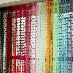 colorful curtains hanging on the side of a wall