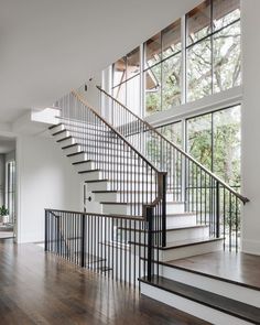 an empty room with some stairs and windows