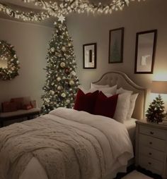 a bedroom decorated for christmas with lights on the ceiling and a tree in the corner