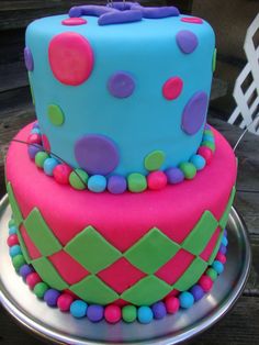 a brightly colored cake with polka dots on it