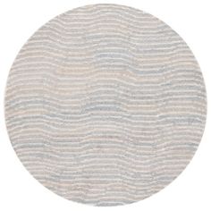 a round rug with waves on it in grey and blue tones, against a white background