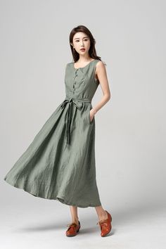 "Step into summer in style with this gorgeous linen sleeveless midi dress! The lightweight and breathable fabric makes it perfect for hot days, while the flowy A-line silhouette and adjustable waist tie create a flattering fit. The button-front and crewneckline add a touch of elegance, making it a perfect choice for both casual outings and special occasions. DETAIL * 50% Linen, 50% cotton * Two side pockets * Sleeveless linen dress * Plus size dress * Belted Linen dress * Midi length * Perfect for summer, spring * Casual linen dress, plus size linen dress * Wash by hand or machine with cold water *The model is 170cm (5′ 7″) tall with a 80cm (31.5\") bust, 66cm (26\") waist. She is wearing in size XS * Choose CUSTOM Order if you Need a better fit Can't find your size in our size Chart Chang Midi Dress Outfit, Sleeveless Linen Dress, Linen Midi Dress, Wool Clothing, Midi Length Dress, Midi Dress Sleeveless, Custom Dresses, Plus Size Dress, Linen Dress