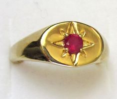 Ruby New with tag. Handsome men's ring in size 10.  The stone is a real ruby from the Niassa mine in Mozambique, and the setting is 14K gold over sterling silver, stamped 925.  The ruby is a deep red.  As with most genuine rubies, this stone may have some inclusions.  It is a 4mm round cut that weighs 0.4cts.  The setting is real 14K gold over sterling silver, and it is crafted with a star that holds the opal in its center.  This ring has a comfortable under gallery, and the ring weighs 4.2 gram Star Ruby, Star Ring, Men's Ring, Size 10 Rings, Mozambique, Deep Red, Round Cut, Ruby, Opal