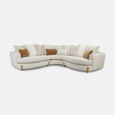 a white sectional couch with pillows on it