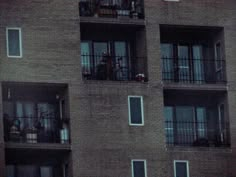 an apartment building with balconies and bicycles on the balconies