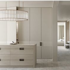 a bedroom with white closets and a chandelier hanging from the ceiling