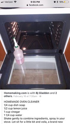 an oven door is open with a bottle of cleaner on the inside and in front