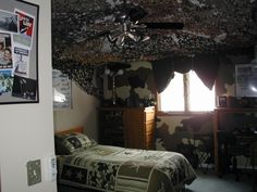 a bed room with a neatly made bed next to a window and a ceiling fan