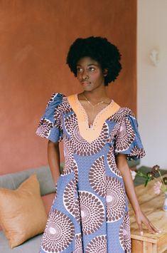 Named after, and drawing inspiration from Annie's West-African grandmother Monica, this dress is infused with the vibrant energy and joyful essence that Ghana is globally celebrated for. Crafted with care, the Monica dress embodies the essence of comfort and style, skilfully fashioned from supple organic cotton. The dress boasts voluminous puff sleeves that elegantly contrast with a gracefully curved waistline, creating a captivating silhouette that exudes confidence. Description: Material: 100% Blue Abstract Print Short Sleeve Dress, Blue Short Sleeve Dresses With Abstract Print, Blue Short Sleeve Dress With Abstract Print, Fitted Blue Dress With Bold Print, Blue V-neck Mini Dress With Vibrant Print, Blue Bohemian Dress With Abstract Print, Blue V-neck Dress With Vibrant Print, African Grandmother, Monica Dress