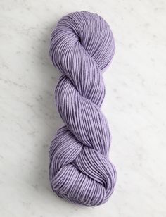 a skein of purple yarn sitting on top of a white counter