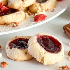 two cookies with jam and nuts on the side