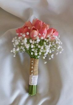 a bouquet of pink tulips and white baby's breath