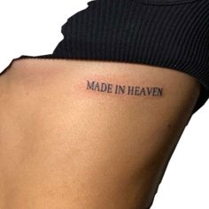 a woman's stomach with the words made in heaven tattooed on her lower back