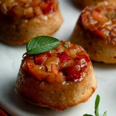 small pastries on a white plate with green leaves