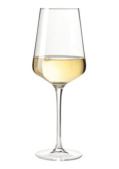 a wine glass filled with white wine on top of a table