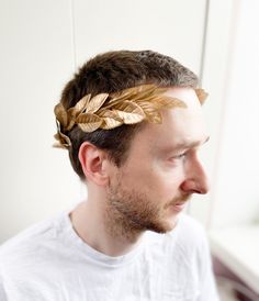 Elevate your special occasion with this exquisite gold laurel wreath, a symbol of triumph, victory, and achievement since ancient times. Crafted with meticulous attention to detail, this wreath features delicate golden leaves, creating a stunning and elegant piece. SIZE: The size is adjustable. It is suitable both for a child and an adult. MATERIAL: high-quality artificial leaves, and high-quality accessories. 100% handmade I accept individual orders The order is packed in a cardboard box and be Gold Laurel Wreath Crown, Gold Laurel Wreath, Laurel Crown, Artificial Leaves, Leaf Crown, Headband Men, Hair Wreaths, Laurel Leaves, Artificial Leaf