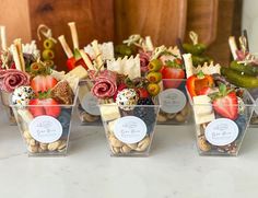 several small plastic containers filled with different types of fruit and nuts on a counter top