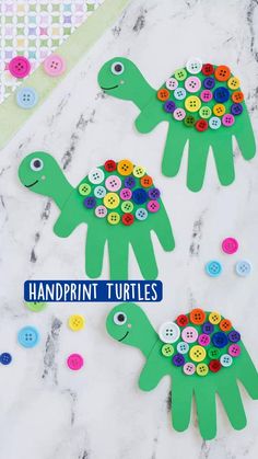 two paper turtles with buttons on them and the words handprint turtles